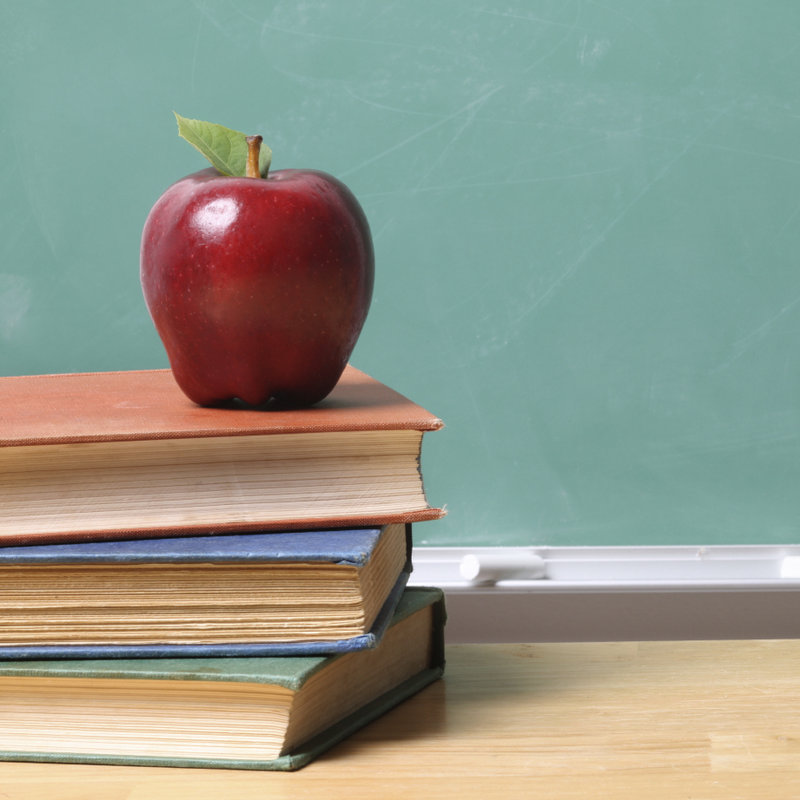 an apple over books describing education